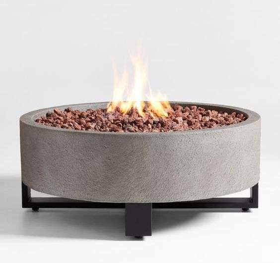 A finished concrete fire bowl, lit